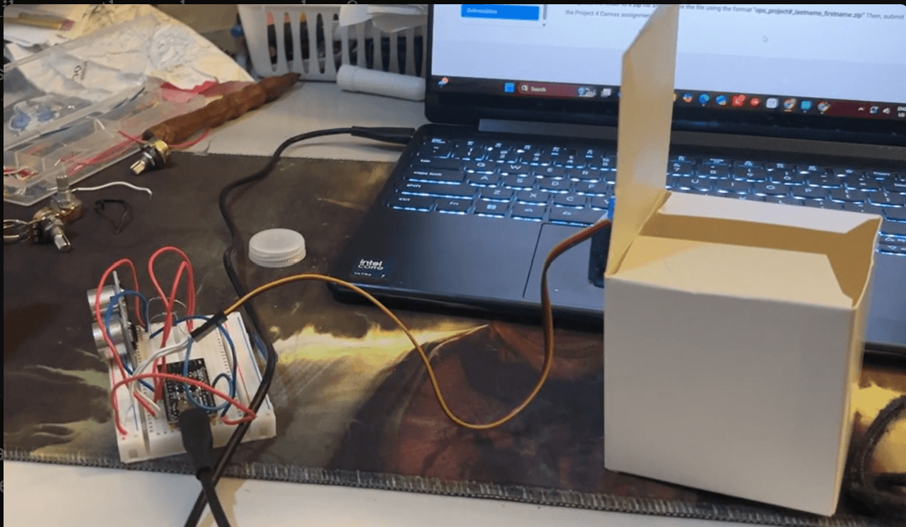 Prototype build with the trash can lid open, driven by a breadboarded ultrasonic sensor and servo